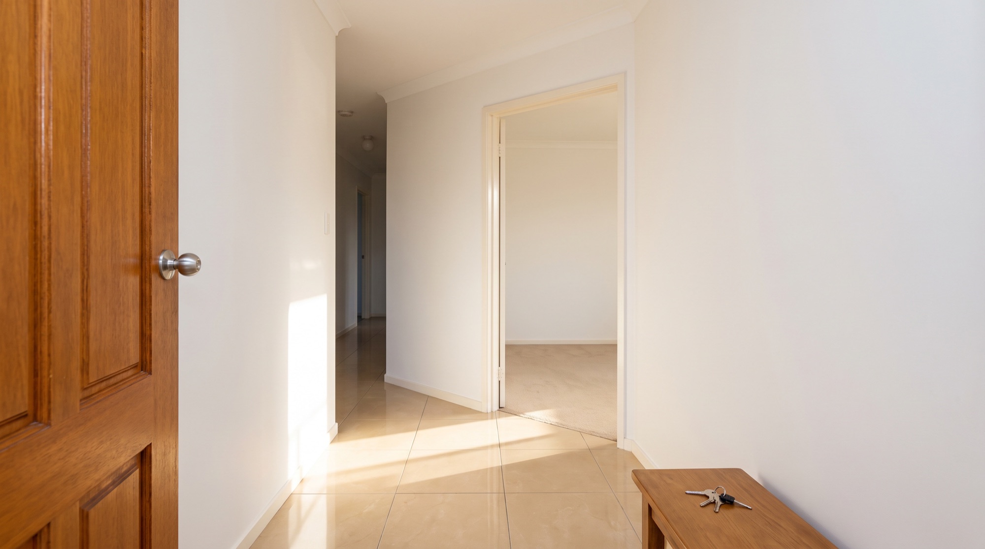 Light falling across a tiled entry inside an open front door